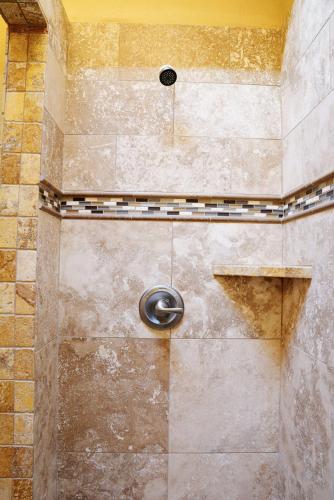 a shower with a shower head in a bathroom at Iron Horse Inn in Granbury
