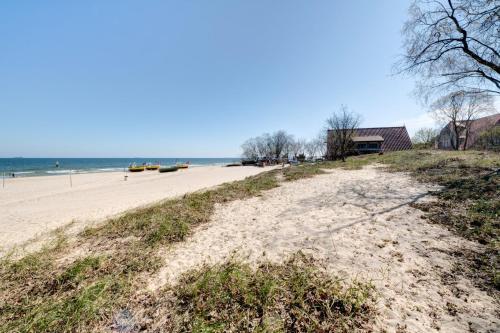a sandy beach with boats in the water at DR Apartments - Kos in Sopot
