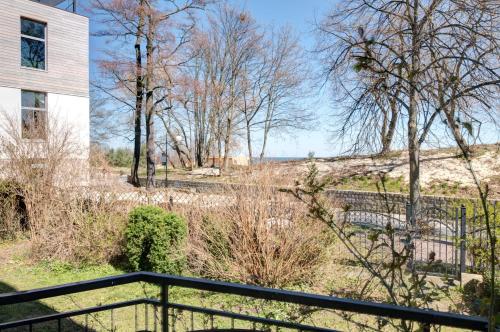 a view from the balcony of a house with a fence at DR Apartments - Kos in Sopot