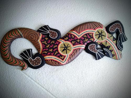 two masks are hanging on a wall at Hotel el Atajo in Yopal