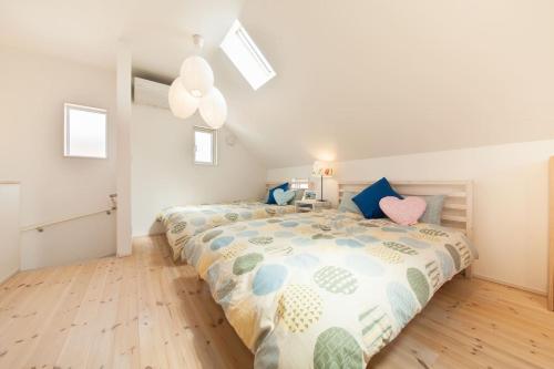 a bedroom with a large bed with blue pillows at 那須塩原にある貸別荘 レンガの家Ｓｏｒａ in Nasushiobara