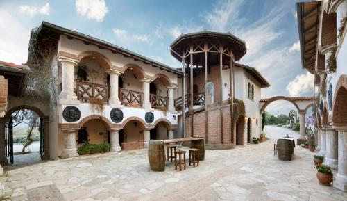 a large building with a clock tower on a street at VINIFERA VINEYARDS HOTEL in Selcuk