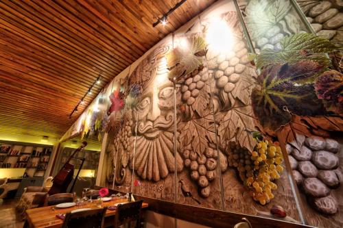 a wall in a restaurant with a painting on it at VINIFERA VINEYARDS HOTEL in Selcuk