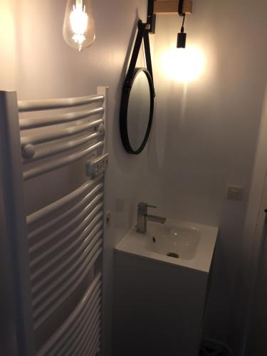 a bathroom with a sink and a mirror at Le gite du Frene in Poses