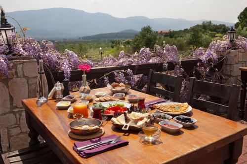 a wooden table with food on top at VINIFERA VINEYARDS HOTEL in Selcuk
