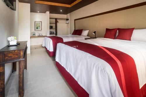 Posteľ alebo postele v izbe v ubytovaní HOTEL Y RESTAURANTE HACIENDA LOS VOLCANES