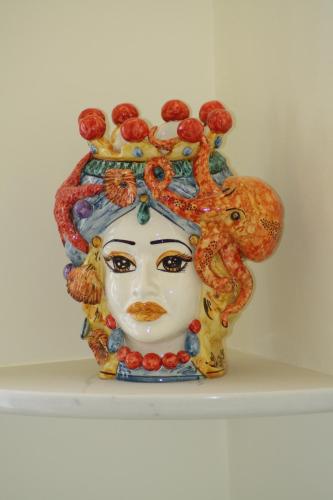 a vase with a statue of a woman at Ines bed and breakfast in Giardini Naxos