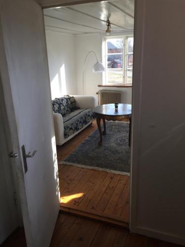 a living room with a table and a couch at Charming house on large property on Vato in Vätö