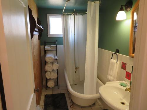 a bathroom with a tub and a toilet and a sink at The Homestead in Chester