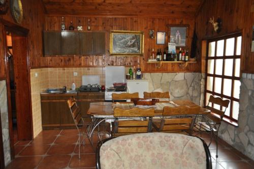 a kitchen with a table and chairs in a room at Forest Home in Golubovci