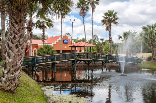 a bridge over a pond with a fountain at Baymont by Wyndham Lake City in Lake City