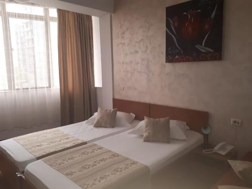 Katil atau katil-katil dalam bilik di Hotel Flormang