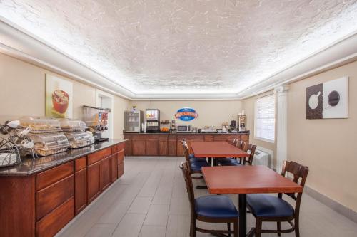 a dining room with two tables and a counter at Baymont by Wyndham Lake City in Lake City