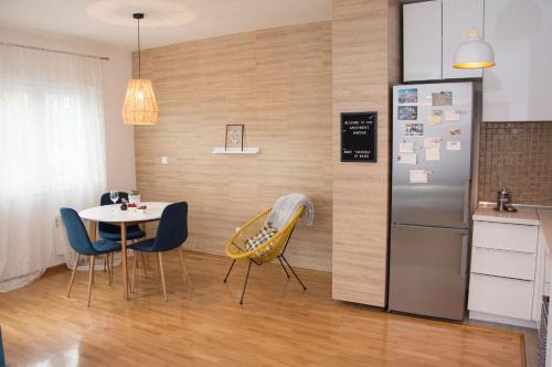 eine Küche und ein Esszimmer mit einem Tisch und einem Kühlschrank in der Unterkunft Apartment Merak in Mostar