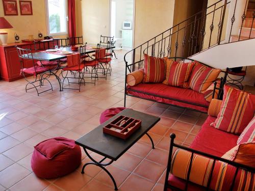 a living room with a couch and tables and chairs at Holiday Home Clos Saint Joseph by Interhome in Lagnes