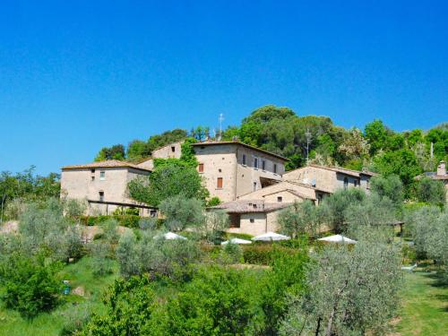 a group of buildings in a field with trees at Apartment Il Forno by Interhome in Monsanto
