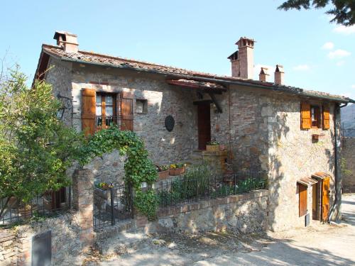 an old stone house with flowers in front of it at Holiday Home Il Casale by Interhome in Lama