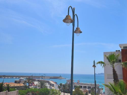a street light with the ocean in the background at Apartment Atarazanas by Interhome in Aduanas