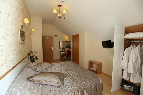 a bedroom with a bed and a chandelier at Hotel Avcilar City in Avcılar
