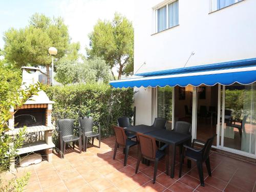 a patio with a black table and chairs and a fireplace at Holiday Home Zona Estival-2 by Interhome in Salou