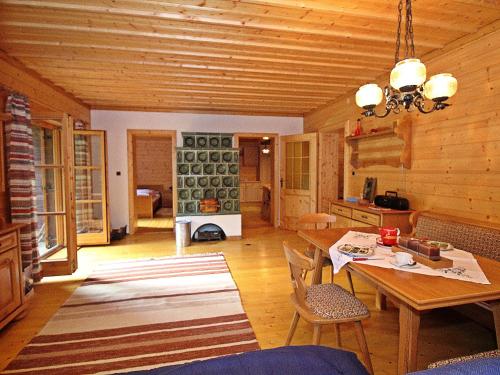 a living room with a table and chairs in a cabin at Chalet Haus Ahlfeld by Interhome in Sankt Aegyd am Neuwalde