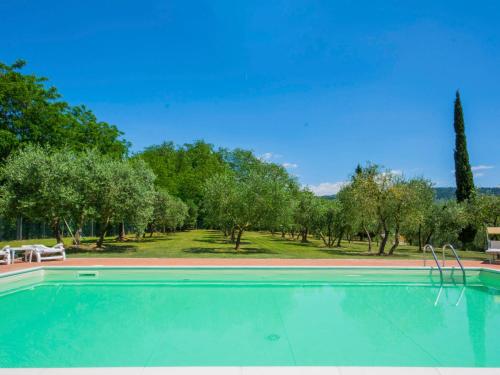 a swimming pool with trees in the background at Villa Beboli by Interhome in Lamporecchio