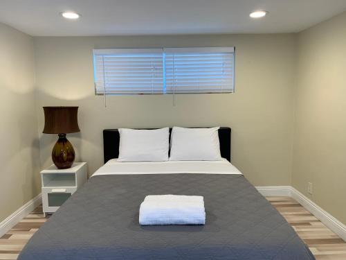 a bedroom with a large bed with a window at Lovely Room in Private House near Disneyland in Anaheim