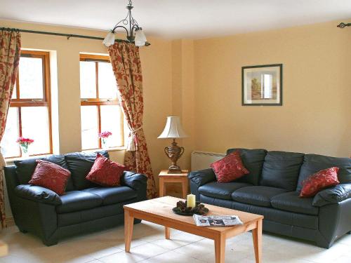 a living room with a couch and a table at Holiday Home Ardgroom-1 by Interhome in Ardgroom