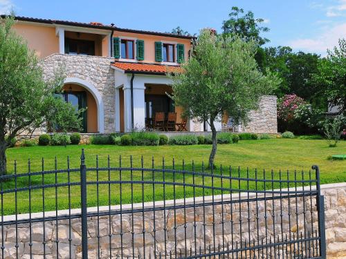 a house with a fence in front of a yard at Villa Marina by Interhome in Diminići