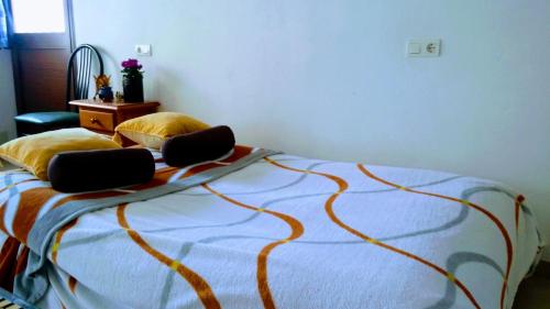a bedroom with a bed with two laptops on it at Apartamento el Parador in Carratraca