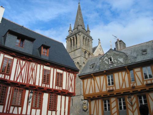 an old building with a tower and a church at Kyriad Vannes Centre Ville in Vannes