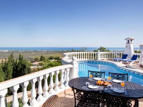 a balcony with a table and chairs and a pool at Villa Villa Ma-Nita by Interhome in Monte Pego