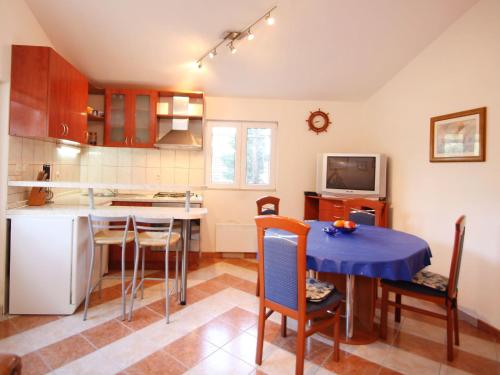 a kitchen and dining room with a table and chairs at Holiday Home Ratimir by Interhome in Rogač