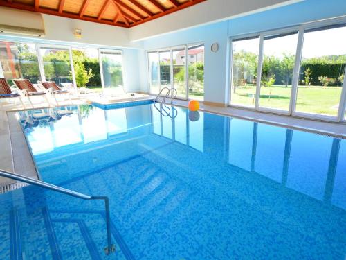 una grande piscina con piastrelle blu in una casa di Villa Marina by Interhome a Betina