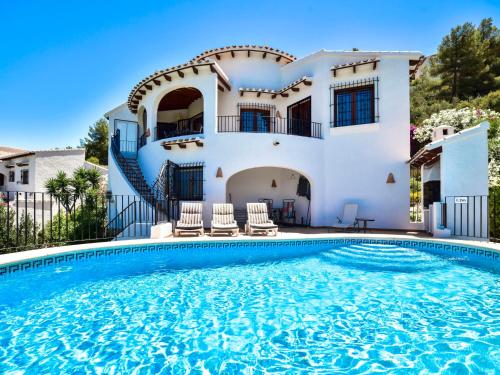 a villa with a swimming pool in front of a house at Villa Villa Clementina by Interhome in Monte Pego
