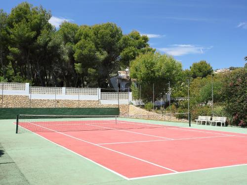 a tennis court with two benches on top of it at Holiday Home Krumel by Interhome in Moraira