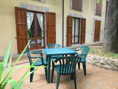 a blue table and chairs in front of a house at Apartment Montecorneo-5 by Interhome in Montebello