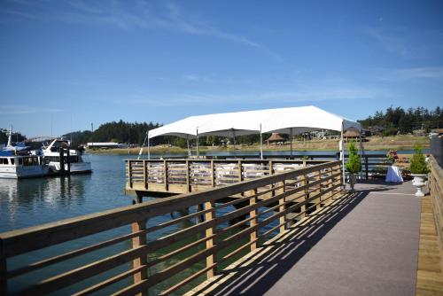 a dock with a white canopy and boats on the water at La Conner Channel Lodge in La Conner