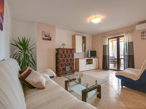a living room with a couch and a glass table at Apartment Ivković-1 by Interhome in Štinjan