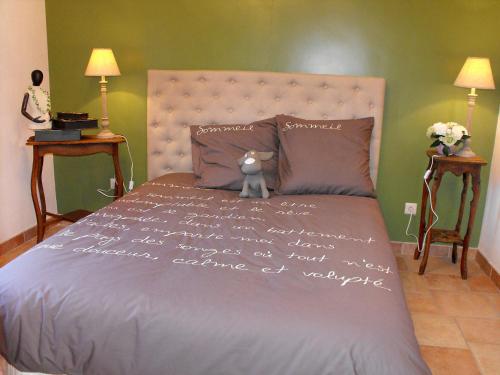 a bed with a teddy bear sitting on top of it at Holiday Home La Ferme de Gabrielle by Interhome in Le Bizet