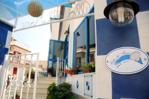 a sign on the side of a building with a fish on it at Hotel Villa Del Mare in Bacoli