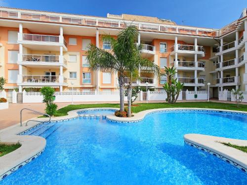 a swimming pool in front of a building at Apartment Estrella del Mar by Interhome in Denia