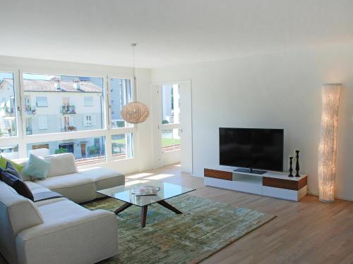 a living room with a couch and a flat screen tv at Apartment LaVille B-2-3 by Interhome in Locarno