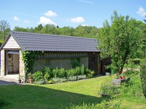 a house with a garden in front of it at Holiday Home Vielsalm by Interhome in Vielsalm