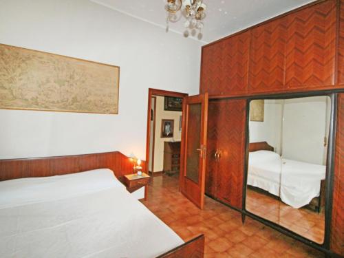 a bedroom with a bed and a mirror at Apartment Sabrina by Interhome in Nesso