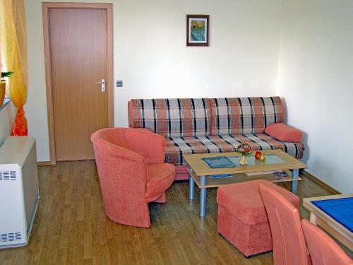 a living room with a couch and chairs and a table at Holiday Home Goetheallee by Interhome in Krakow am See