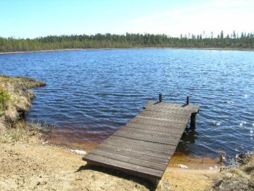 a wooden dock in the middle of a lake at Holiday Home Akanlampi by Interhome in Karvonen