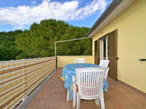 a patio with a table and chairs on a balcony at Apartment Dada-2 by Interhome in Omišalj
