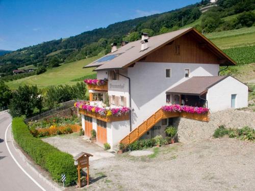 a house with flower boxes on the side of it at Brunnerhof in Feldthurns