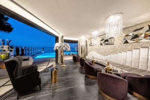 a hotel lobby with chairs and a pool at Posh Residence Luxury Suites in Split